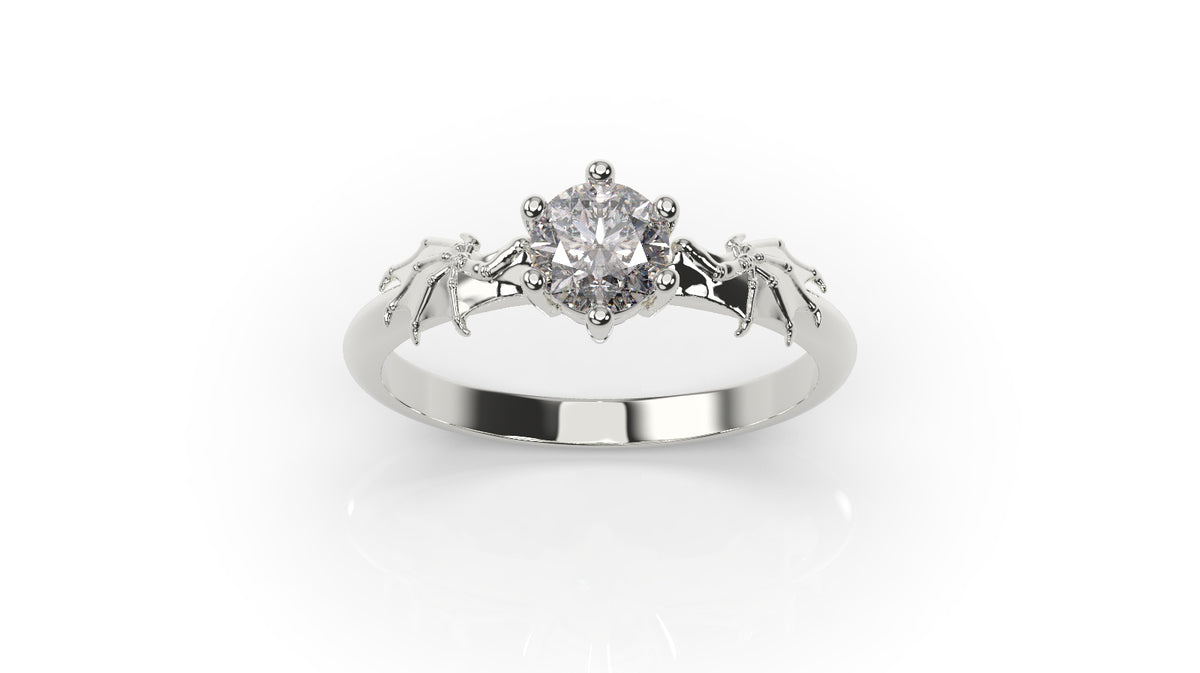 White gold ring with bat wing details and a round center stone